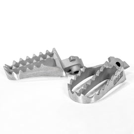 IMS Pro Series Footpegs for motorcycle foot controls, featuring durable metal construction with textured surfaces for grip.