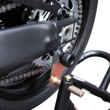 Load image into Gallery viewer, Black Shogun Industries swingarm sliders attached to a motorcycle's body, designed to protect the bike's swingarm during falls.