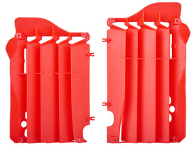 Red Polisport Plastics radiator louvers for motorcycle, part number 64-56538, shown on a vehicle radiator.