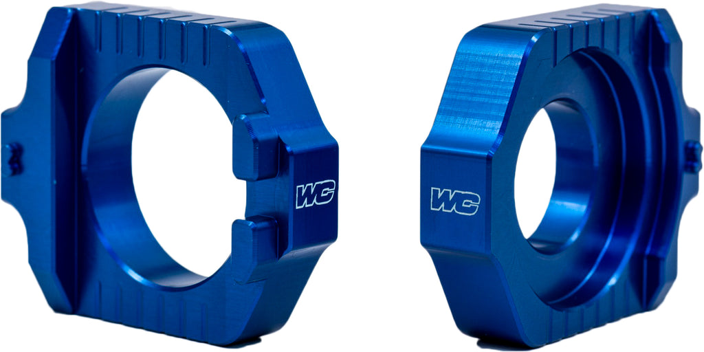 WORKS Axle Blocks Elite KTM and Husqvarna drive accessories, showing durable black metal design for motorcycle wheel stability.