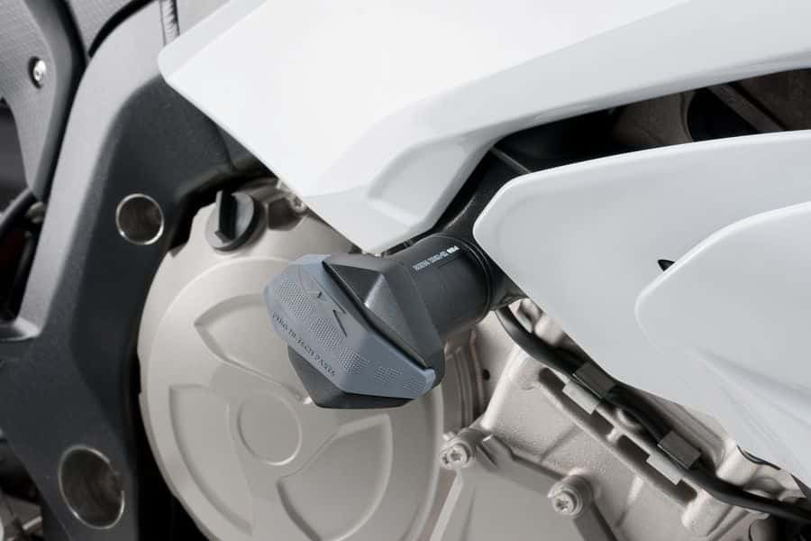Black PUIG Frame Sliders for BMW R19 motorcycle, mounted on body, providing protection and a sleek racing look.