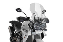 Load image into Gallery viewer, Clear PUIG touring windscreen for motorcycle, showcasing its curved design and mounting points for enhanced wind protection.