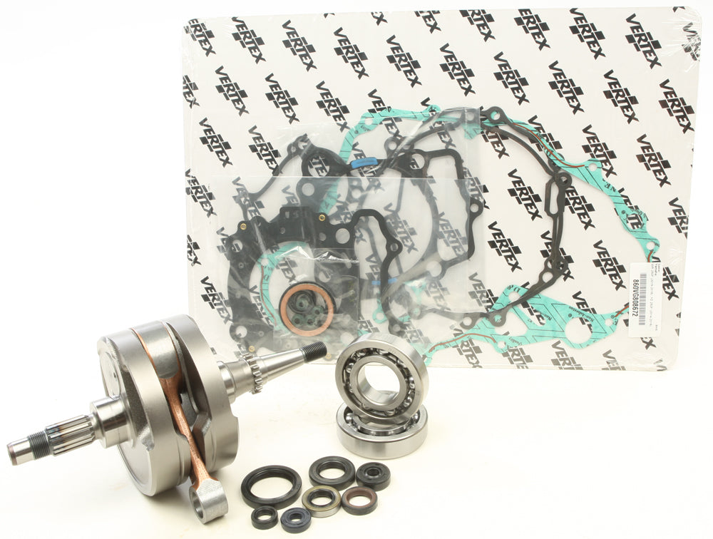 Hot Rods Complete Bottom End Kit 421-0205 engine components with pistons, crankshaft, and connecting rods arranged on a workbench.