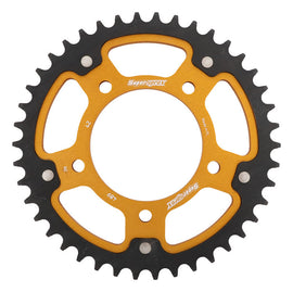 Supersprox rear stealth aluminum and steel 42-tooth street sprocket for Kawasaki motorcycle, shown in gold with detailed teeth.