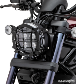 Black ZETA headlight guard for illumination, designed to protect motorcycle headlights with durable metal mesh.