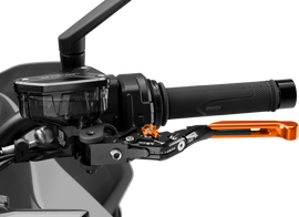 PUIG Clutch Lever 4.0 Fold/Extend in bright orange for motorcycles, showing the ergonomic design and adjustable features.