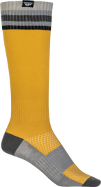 Fly Racing youth motocross socks in yellow, featuring thin, breathable fabric with reinforced heel and toe for riding comfort.