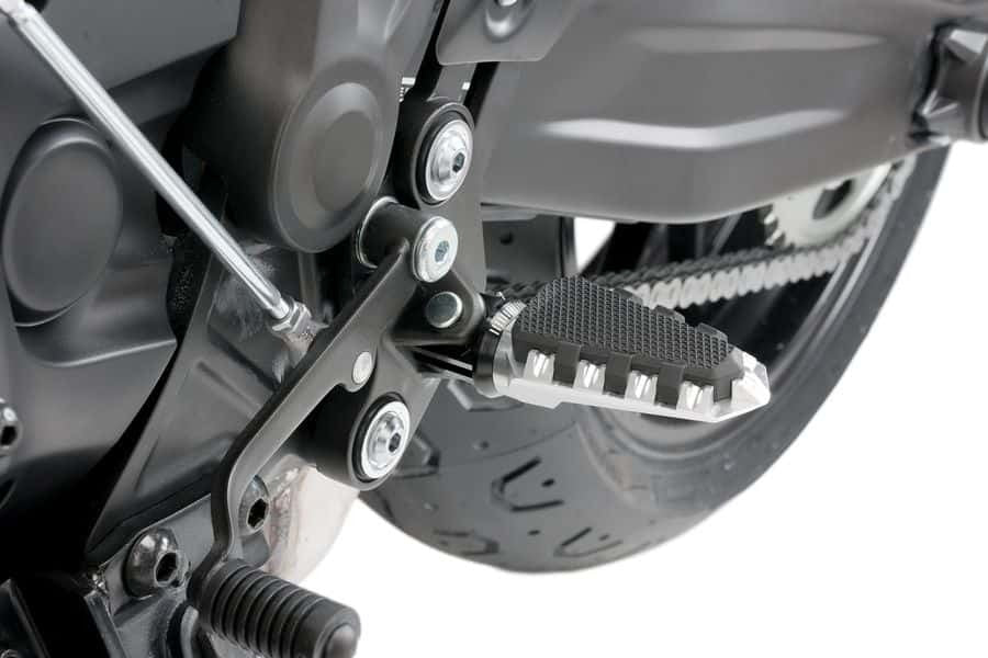 Silver PUIG trail footpegs for Suzuki GSX-R750 motorcycle, mounted on the bike's footpeg brackets and designed for off-road riding.
