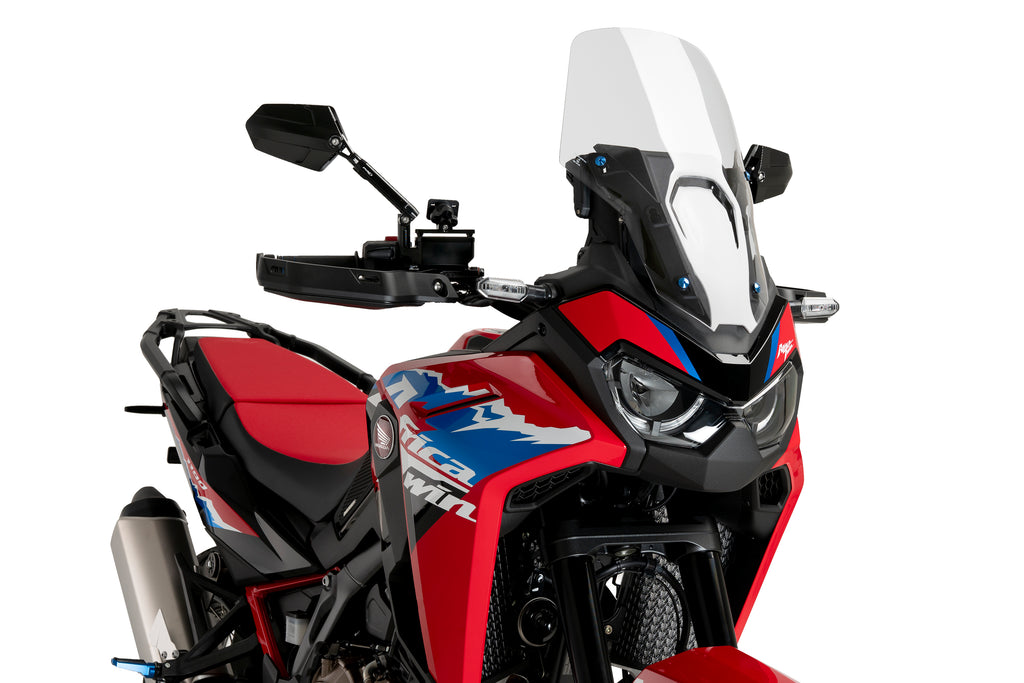 Clear PUIG touring windscreen for motorcycle, showcasing its transparent, curved design ideal for wind protection.