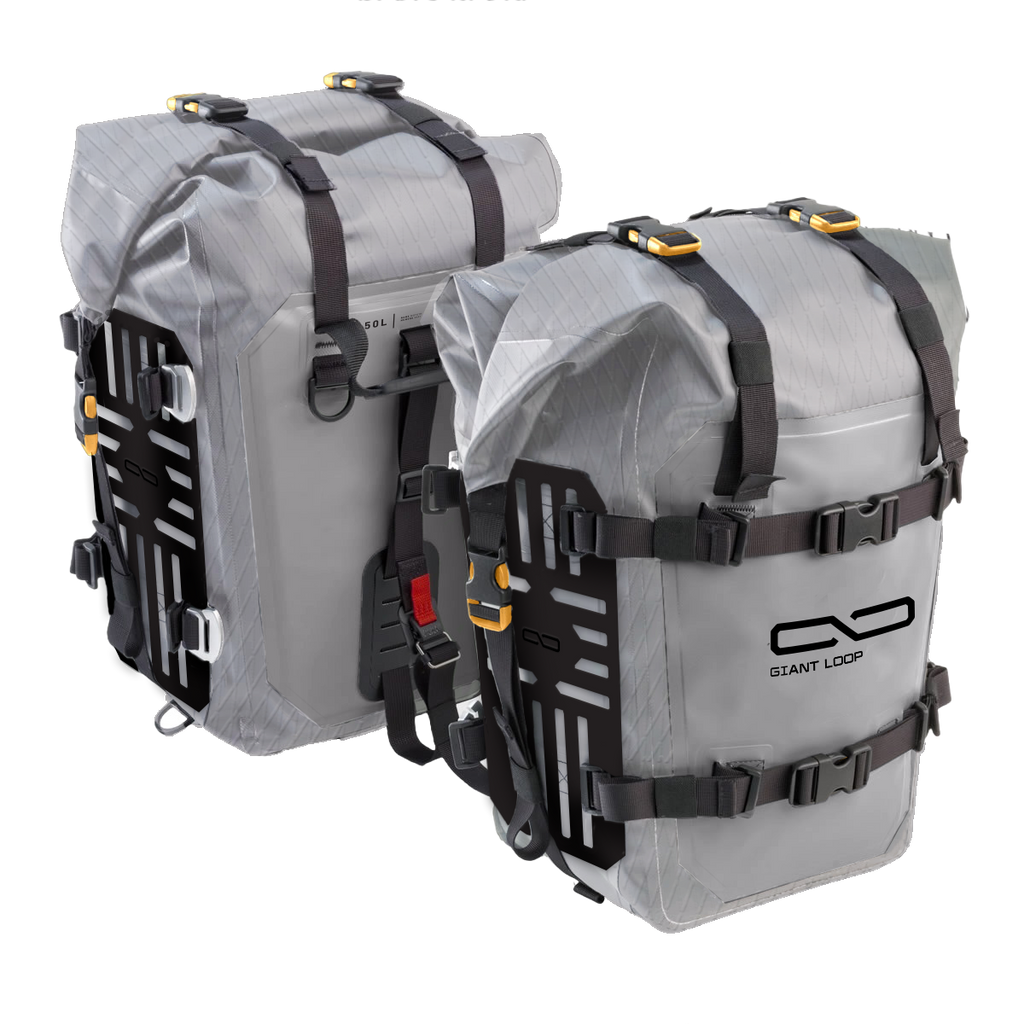 Pair of grey Giant Loop Mototrekk motorcycle panniers for luggage storage, shown mounted on a bike.