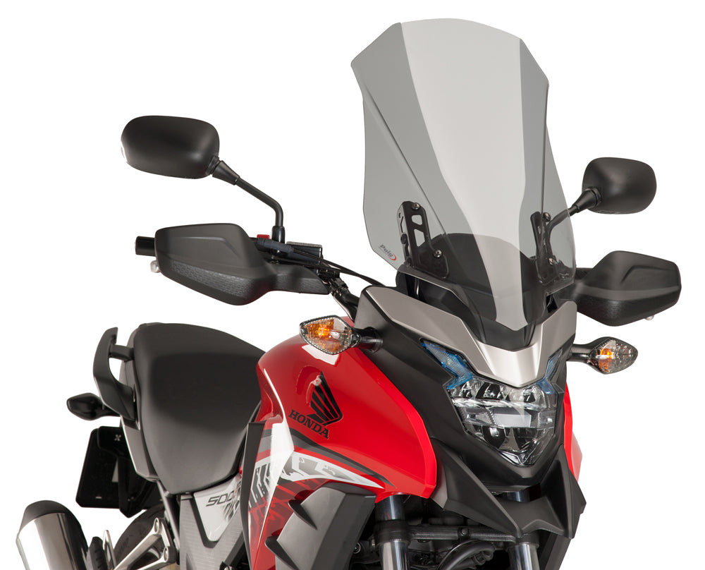 PUIG Touring Smoke Windshield for motorcycle, clear tinted windscreen with aerodynamic design and mounting hardware.