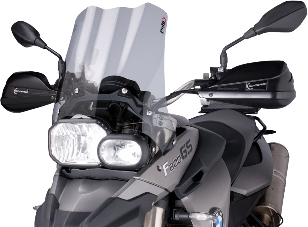 PUIG Touring Smoke Windscreen for motorcycle, clear tinted windshield with aerodynamic design and mounting hardware visible.
