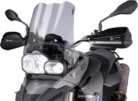 PUIG Touring Smoke Windscreen for motorcycle, clear tinted windshield with aerodynamic design and mounting hardware visible.