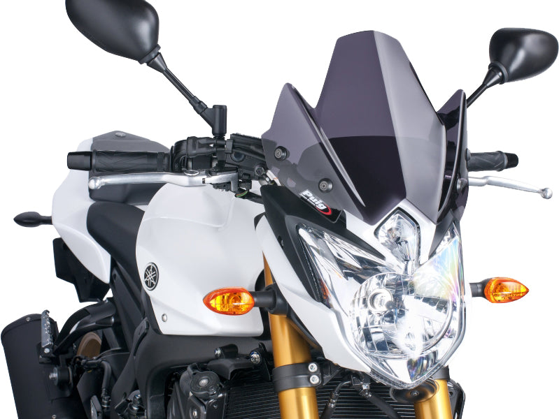 PUIG Naked New Gen Sport dark smoke windshield, motorcycle windscreen with sleek tinted design for enhanced aerodynamics.