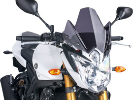 PUIG Naked New Gen Sport dark smoke windshield, motorcycle windscreen with sleek tinted design for enhanced aerodynamics.