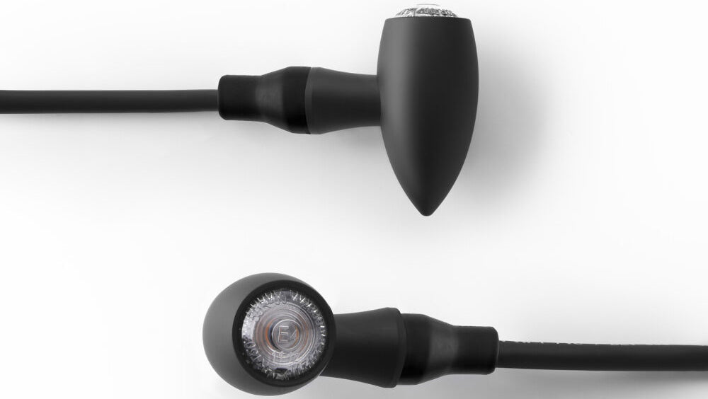 Pair of RIZOMA Club Turn Signal black illumination lights for motorcycles, featuring sleek black housing and clear lenses.