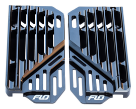 Flo Motorsports black high flow radiator braces installed on a vehicle, showcasing durable metal construction and secure mounting.