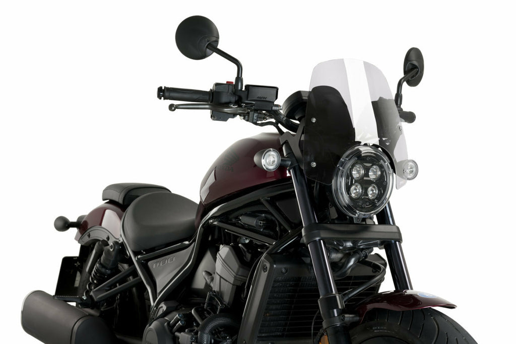 Clear PUIG Nng Sport motorcycle windshield showing sleek, aerodynamic design with mounting points against a neutral background.