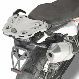 GIVI rear luggage rack for KTM motorcycle, showcasing sturdy metal construction and mounting points on the bike.