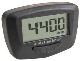 Koso North America Proton RPM and hour meter gauge, black display with digital readout, mounted on a vehicle dashboard.
