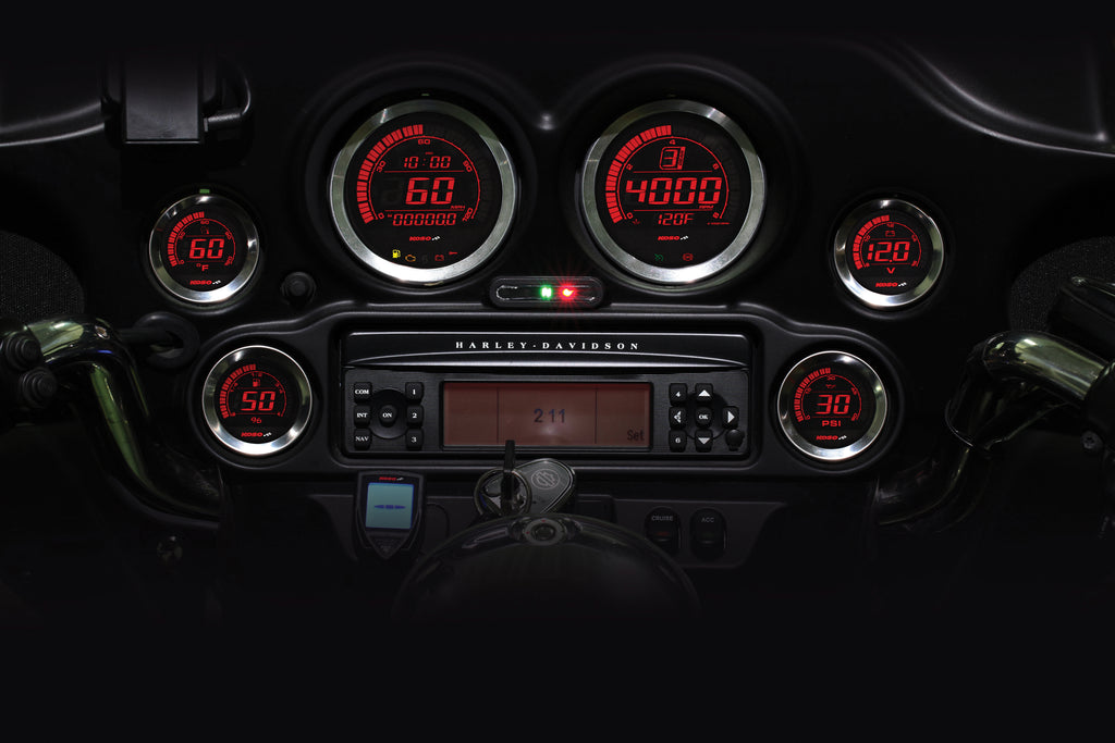 Koso North America HD-02 Series gauge kit with silver bezel displaying oil temperature readings on a motorcycle dashboard