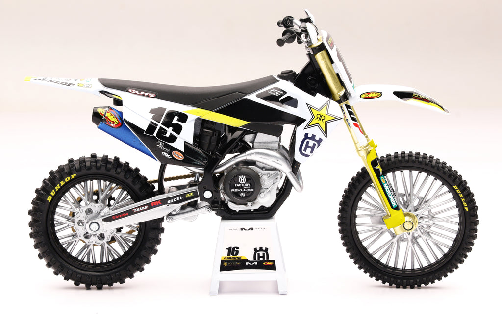 New Ray Toys 1:12 scale Rockstar Husqvarna Zach Osborne #16 motocross accessory with detailed bike parts and branding.