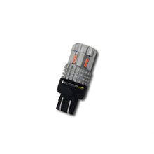 Load image into Gallery viewer, Pathfinder high performance LED bulb 7443 red, clear view of the bulb with red tint, designed for automotive lighting.