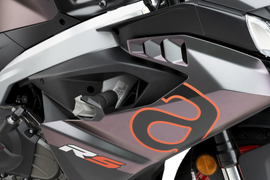 PUIG R19 black frame sliders for motorcycle protection, shown on a motorcycle with a sleek black finish.