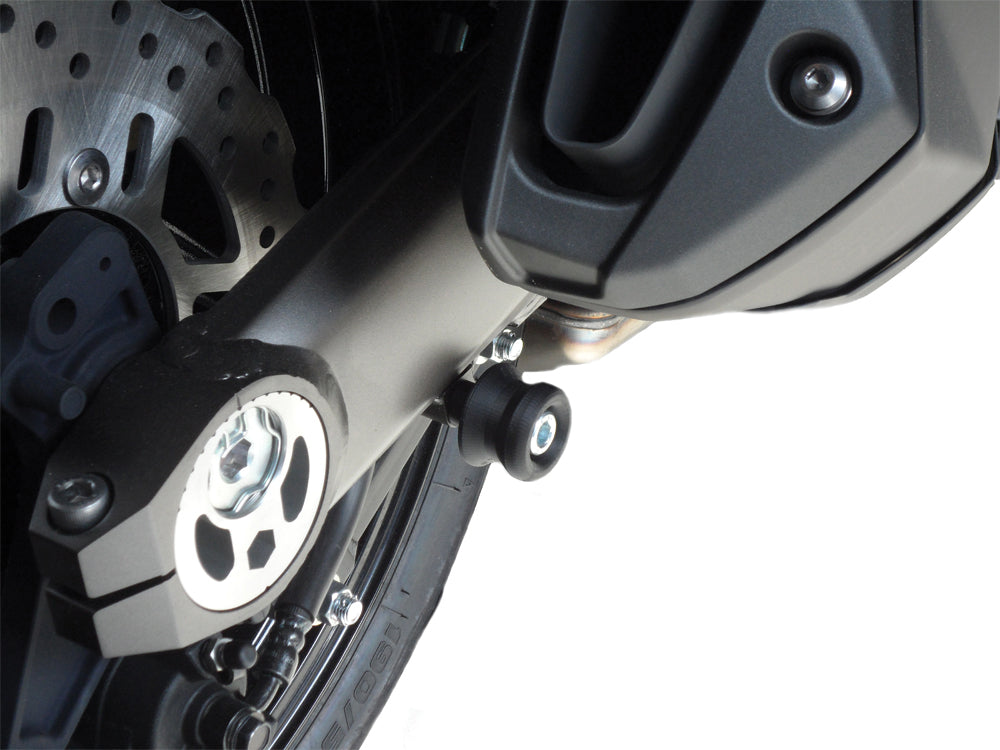 Shogun Industries black swingarm sliders for 71-1040 model motorcycle, mounted on the bike's body for protection.